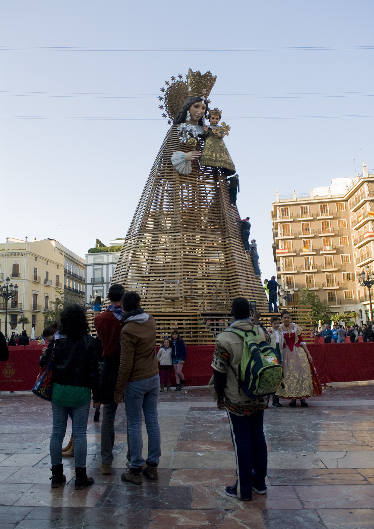 A great wooden structure depicting the Virgin Mary holding baby Jesus is located in the city's oldest square. It's a major focal point of the Fallas festivities, as for a couple of days falleras and falleros process from their neighborhoods to the square with bouquets of flowers. The flowers are placed throughout the wooden structure, creating a beautiful dress.