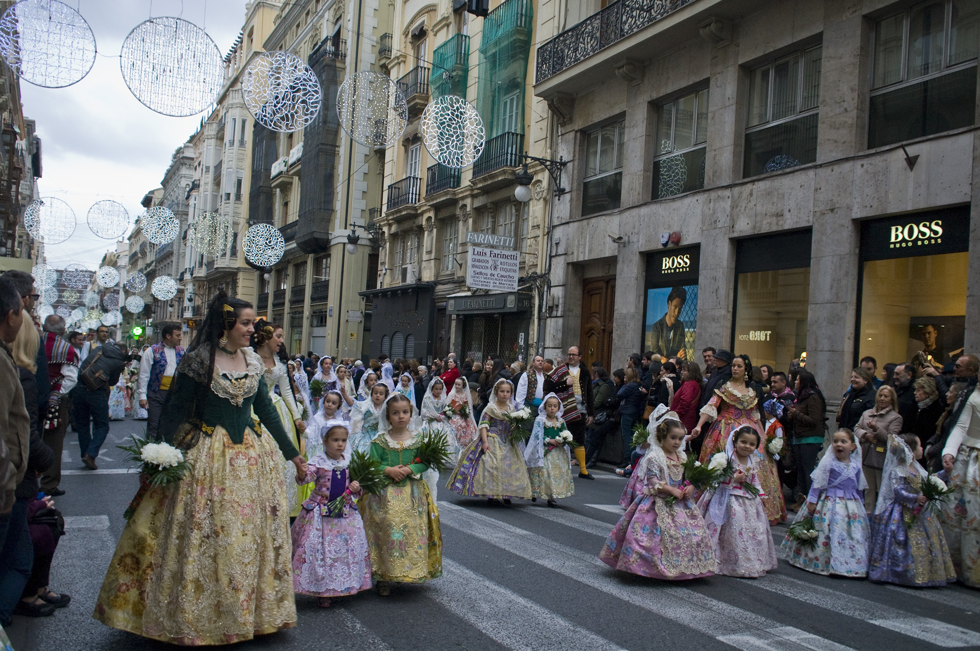 The Ofrenda - literally "offering" in English- is the formal procession the falleras and falleros make to the the Plaza de la Virgen, bringing flowers that will make up her elaborate dress.