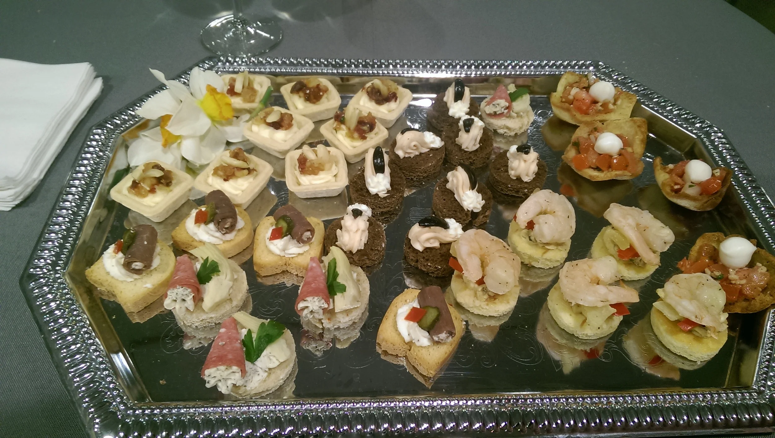 Various Passed Appetizers. Pictured is, Roast Beef Roulades, Salami Cornets, Grilled Shrimp on Jalapeno Coconut Cornbread, Salmon Mousse on Pumpernickel, Bruschetta in Pita Cups, and Baked Brie and Fruit Cups 