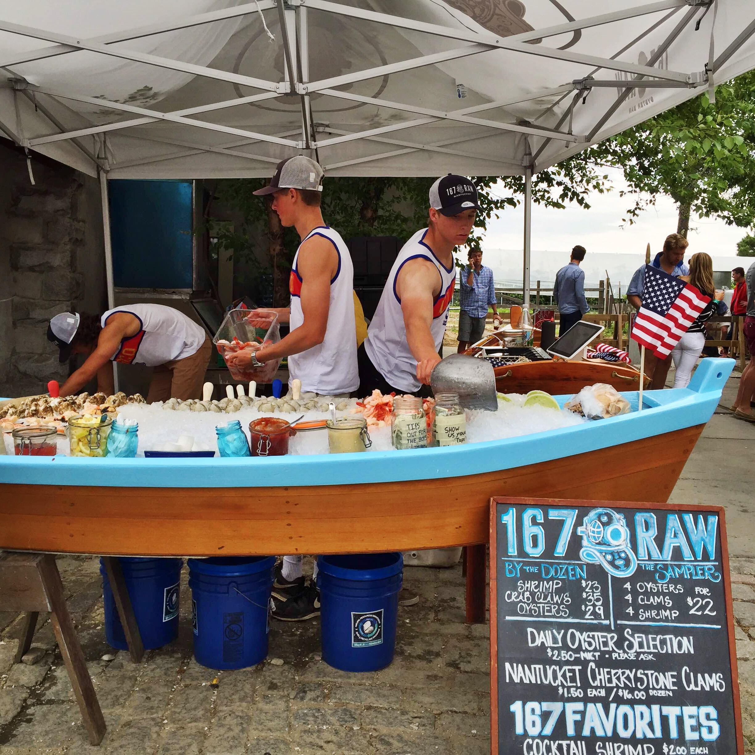 Young lads serving fresh seafood at Cisco Brewery