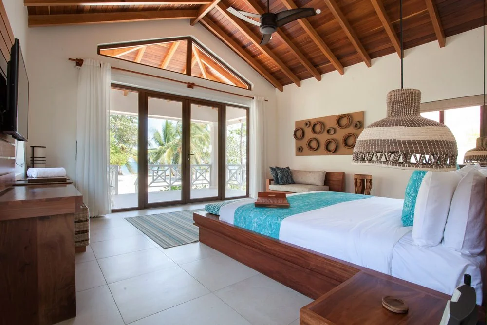 beach front studio suites feature direct views of the sea. with just 10 steps to have your feet in the ocean. wake up to the sound of the ocean and roll out of bed right into a beachfront hammock. these studio suites are designed with local belizean hard woods, 1 King Bed, outdoor garden rain shower and luxury amenities.