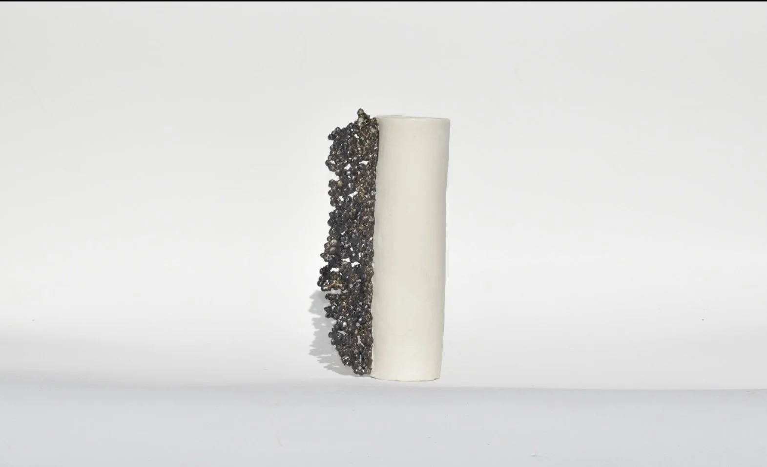 CELLS vases (tall) black/white material stoneware/porcelain. 10 1/2 x 3 x 4 1/2 inches and $360 each. 