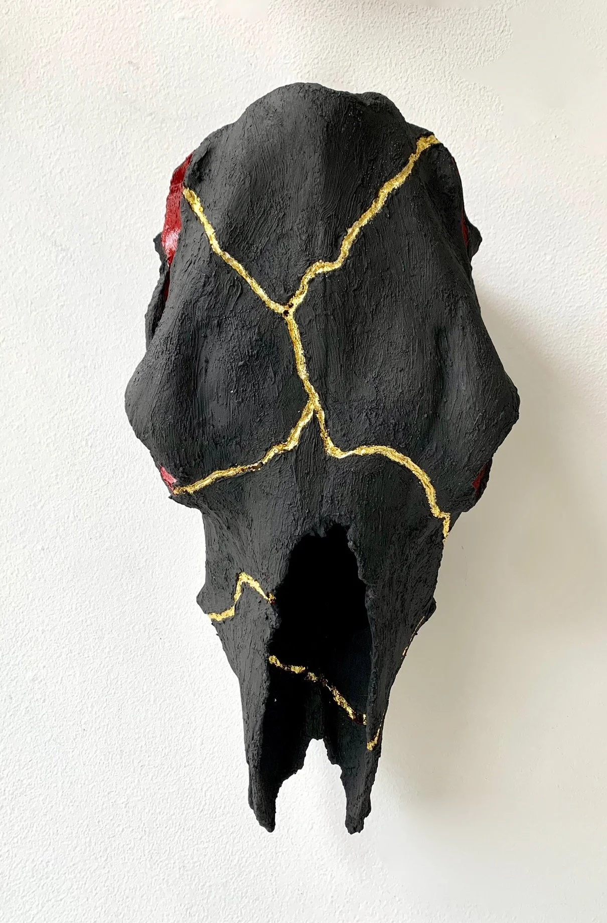 Wabi-Sabi | Black Clay, Gold Leaf, Red Varnish on Cow Skull | 20" x 10" x 6.5" | $950