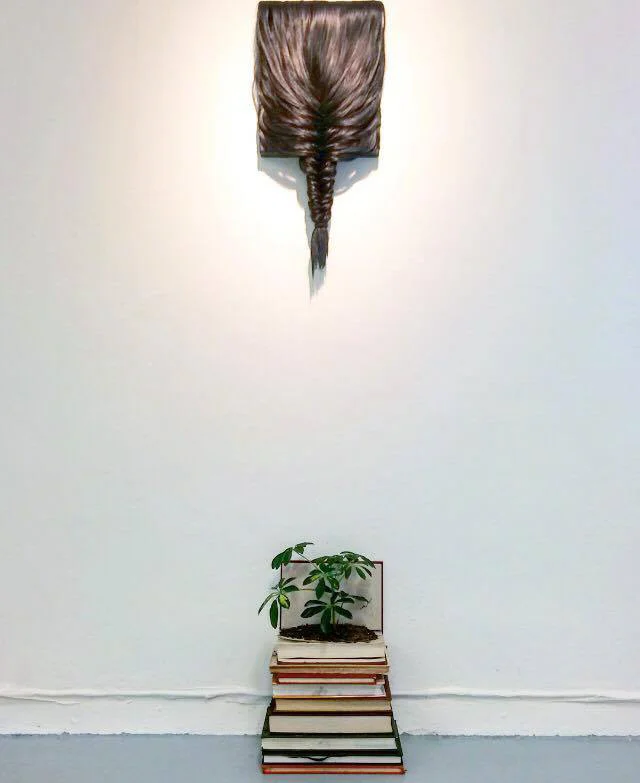 above: The back of my head Hair and wax on wood panel. below: Daniel Soil, money tree, books.