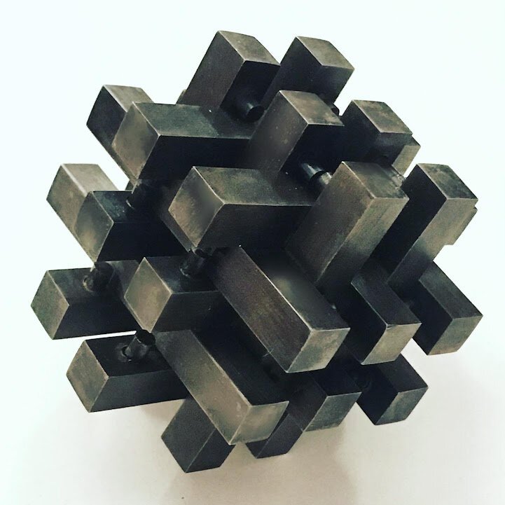  Steel joinery puzzle consisting of 18 interlocking pieces   