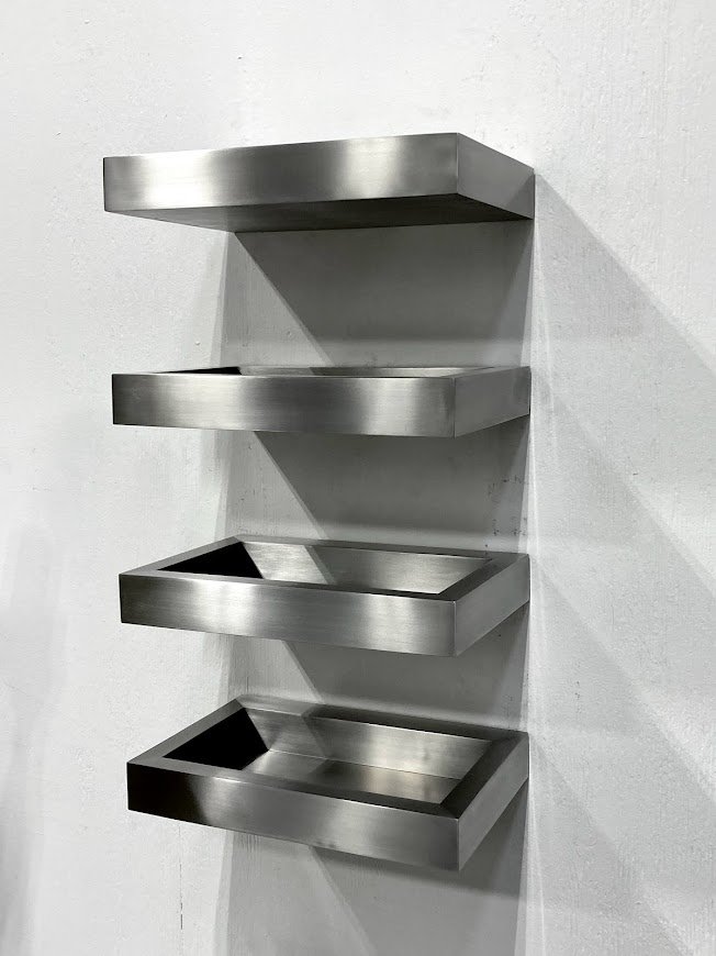  Custom cantilevered stainless steel shelves with a grained satin finish for Kin and Company.  