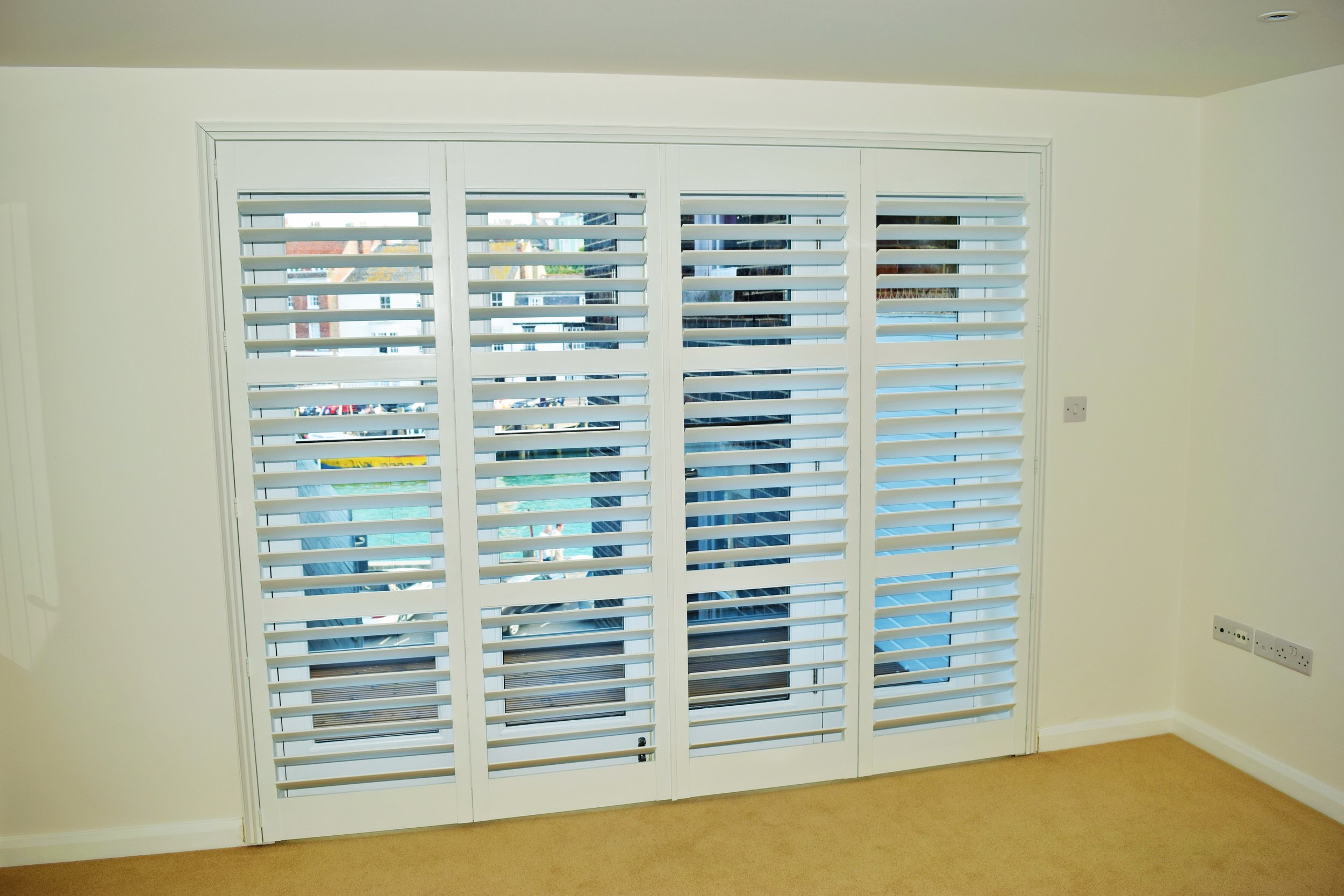 Wooden plantation shutters on large patio doors Weymouth Dorset