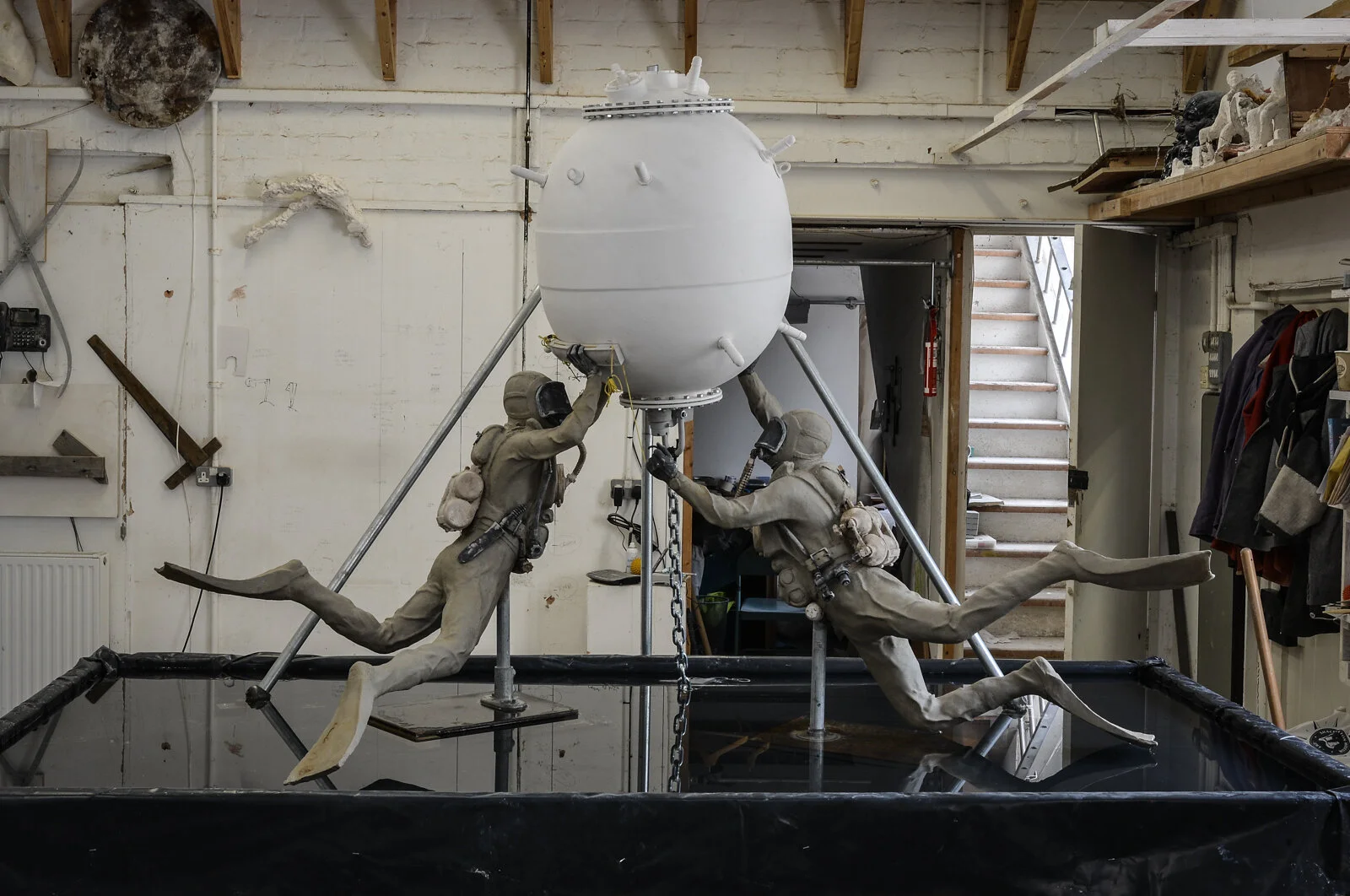 The half life-size sculpture finished in the studio and temporarily displayed on water to test the effect. The steel supports are temporary structural measures. The work is scanned and will be enlarged by CNC and 3D prints x 2.5 bringing the final work to approximately 3.5 m H x 5 m wide. From the scan, we take a small 3D print and photograph it for the rendering and visualisations below.