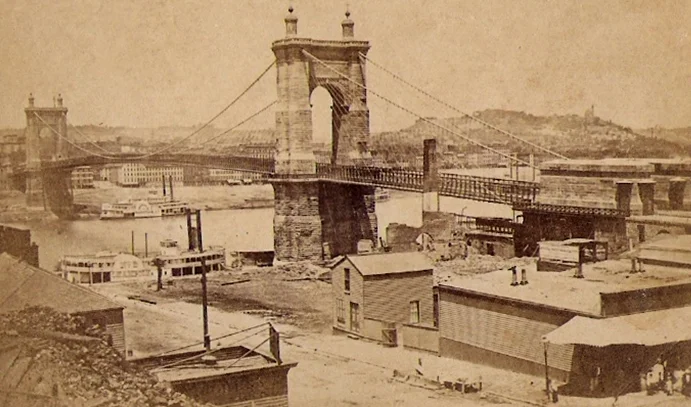 Suspension Bridge over the Ohio River, between Cincinnati, Ohio and Covington, Kentucky, circa 1870. Image source: RoeblingBridge1870.jpg . Licensed under Public Domain Mark 1.0 .