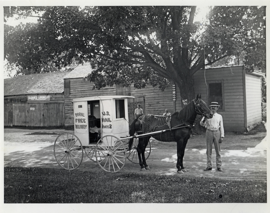 An unidentified rural carrier poses with his horse and wagon, Circa 1905. Image source: Rural Carrier with Horse and Wagon (also Flicker Commons ) by unknown photographer; from Smithsonian Institution, National Postal Museum ; has no known copyright restrictions , fair use