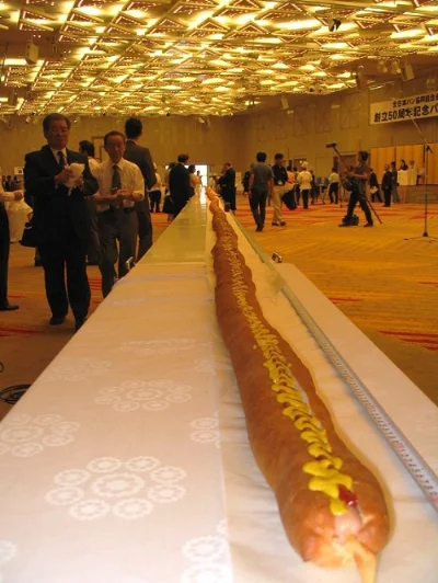 The world's longest hot dog (as of August 4, 2006), measuring 60.3 m, at the Akasaka Prince Hotel, Akasaka, Tokyo, Japan, on August 4, 2006. Image source: 60m Hot Dog Akasaka Aug4 06.jpeg by Tim Lindenschmidt is licensed under Public Domain Mark 1.0