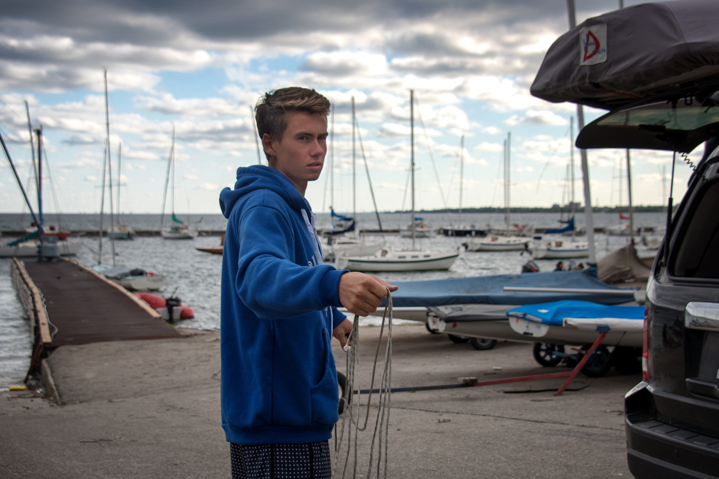 Tying the laser radial onto the roof of the car at Toronto Sailing & Canoe Club in preparation for heading to ILCA Atlantic Coast Championships in Bellport NY.