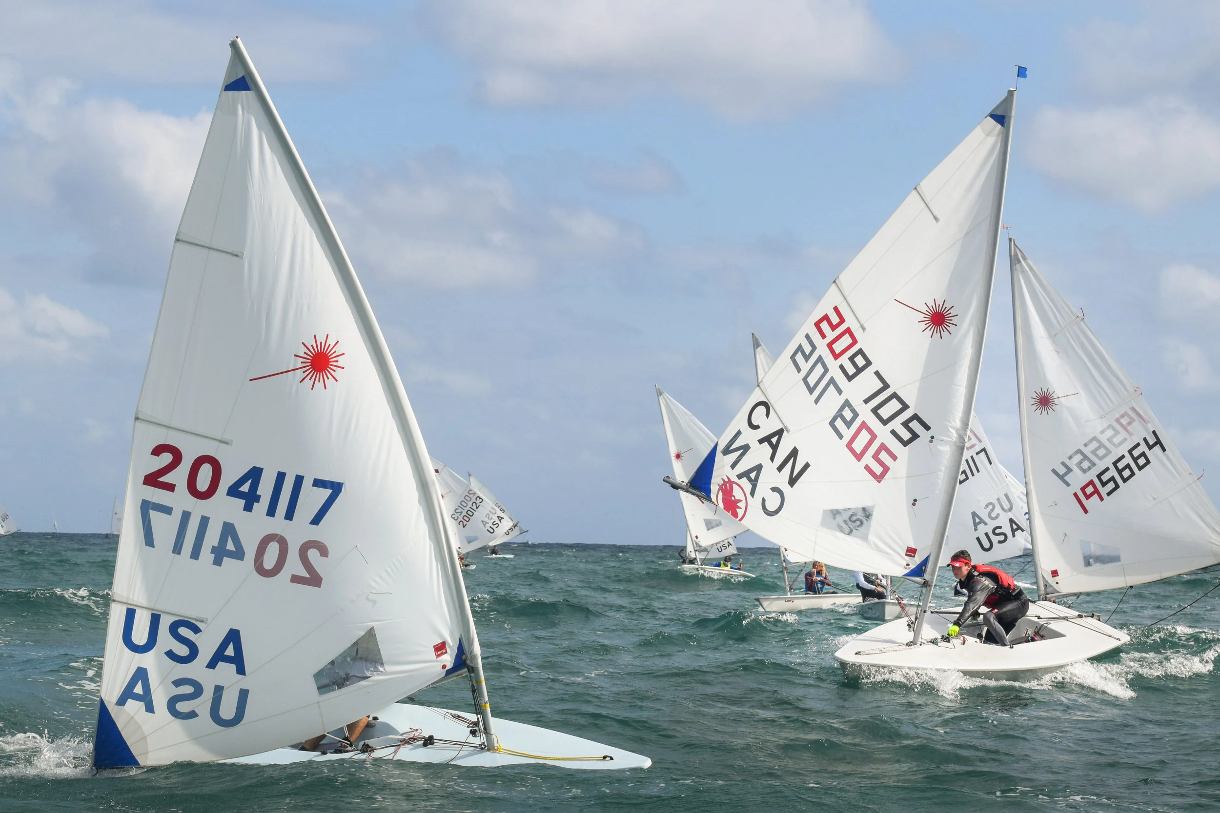Waves made this leeward mark rounding (mark behind boat 204117 on the left of image) a challenge. PHOTO CREDIT: B.Carraway