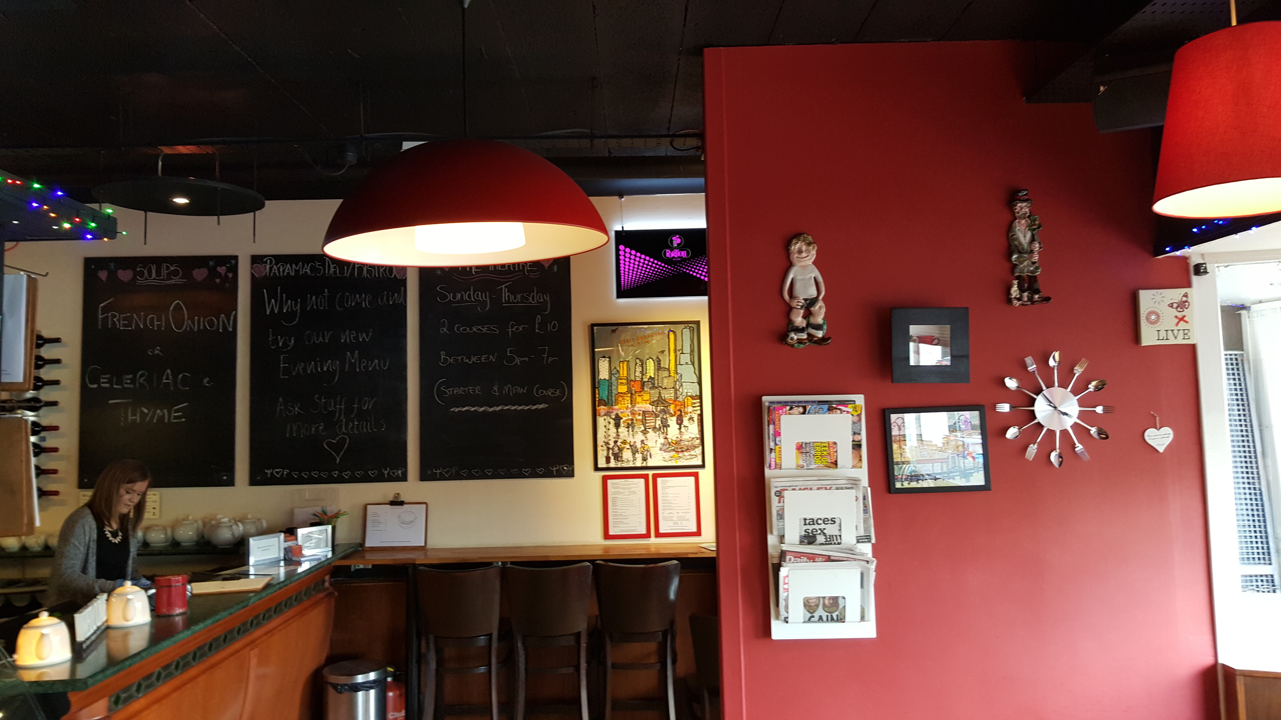 Old chalkboards were updated in-house; omnipresent deep red colour; novelty clock of unknown origin.