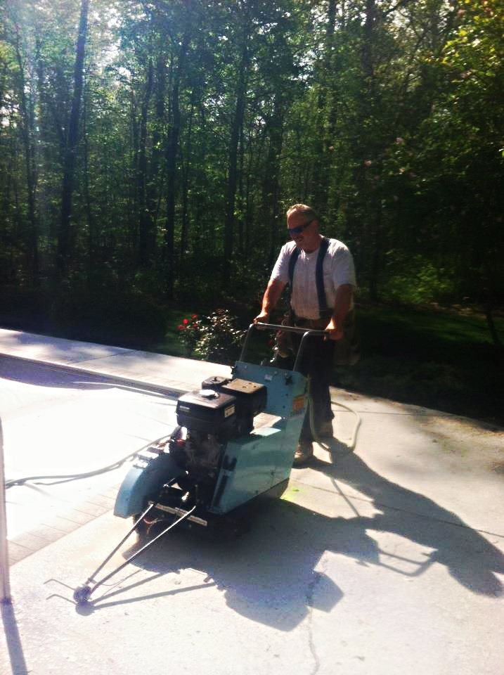 Saw cutting to remove a portion of pool deck to allow for plumbing repairs
