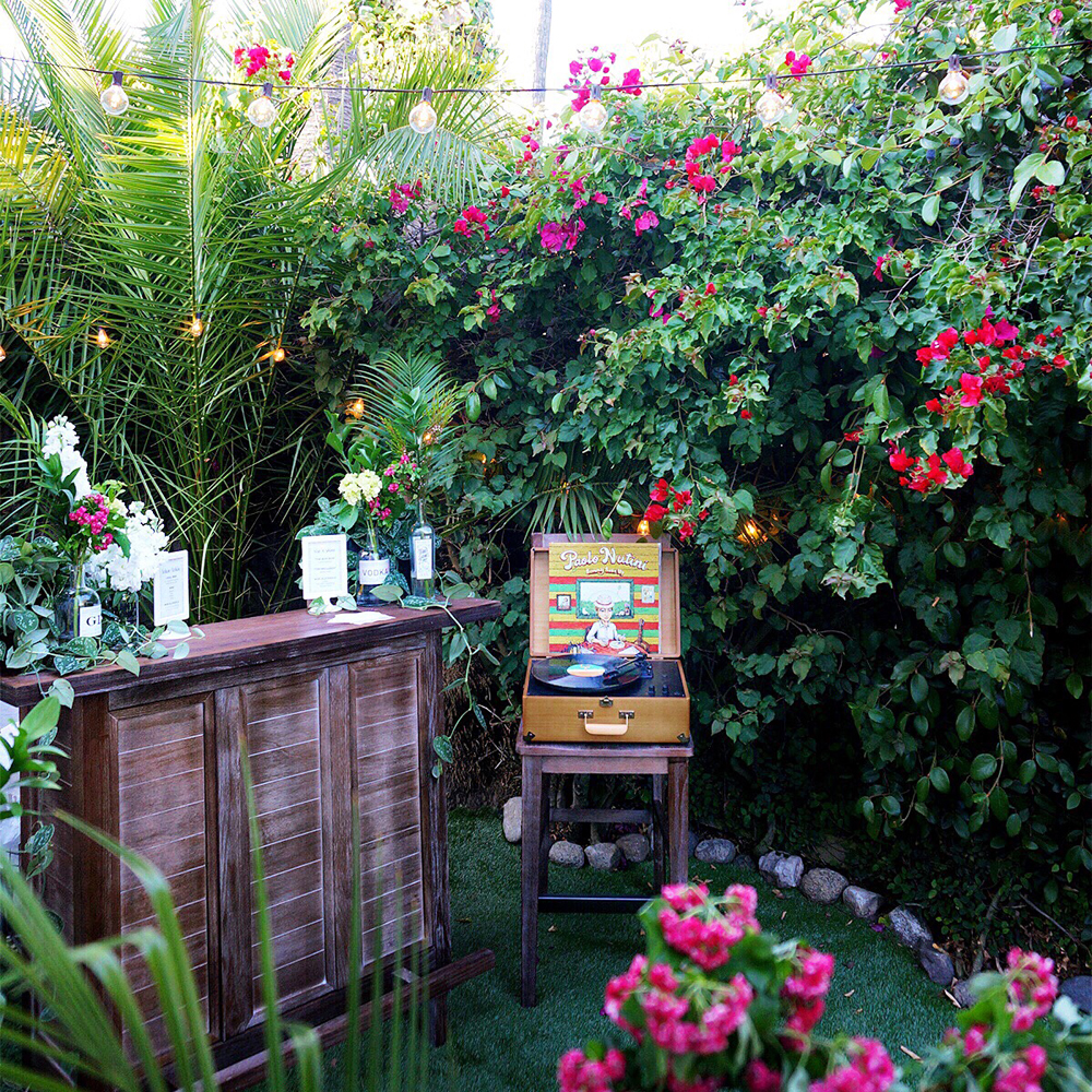 The garden bar (from joss & Main), styled for the wedding events. i used live plants to decorate most areas, but also mixed in some clippings from the flower market. instead of buying event vases, i used bottles and glasses from the companies whose beverages we were serving: small batch oola liquor , santa monica brew works local beer, plus champagne and a selection of wines. Bartending by TaskRabbit .