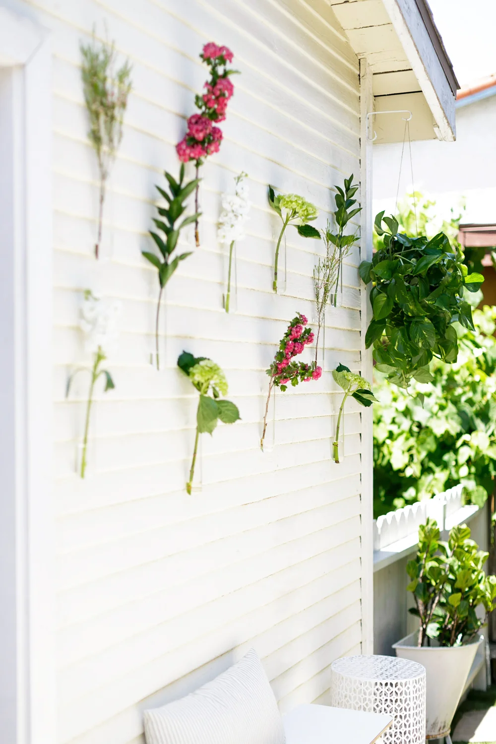 We used beaker vases from cb2 (paired with farmers market clippings) to liven up the blank exterior walls at a minimal cost.