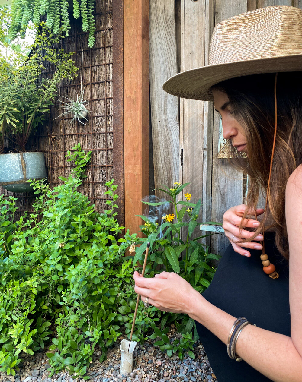 Above: Lighting a non-toxic, bee-safe mosquito repellent stick in preparation for an outdoor movie night during sunset.