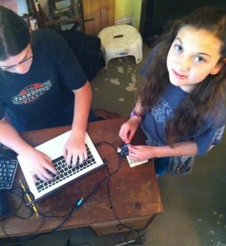 Beth and Sami getting some Arduino practice. They will build a gumball machine that releases candy only when you give the machine the correct secret knock.