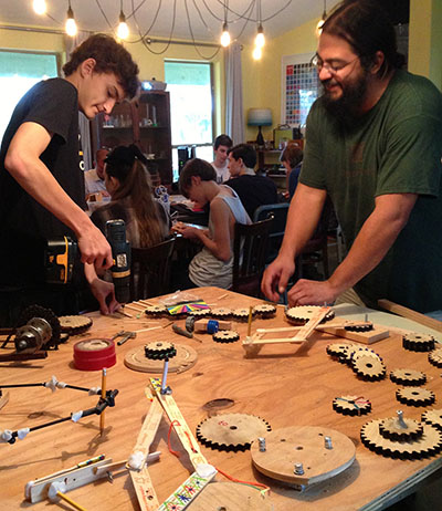 Wyeth and art teacher Johnny Villarreal working on a drawing machine.