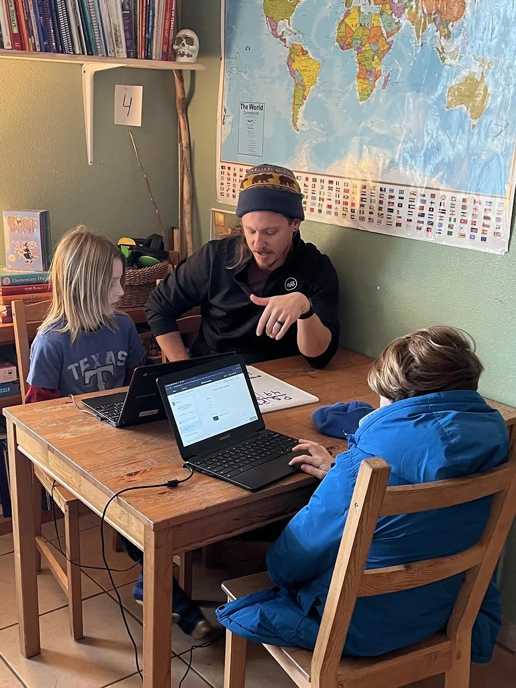 A mentor with studets at Whole Life Learning Center in Austin, Texas