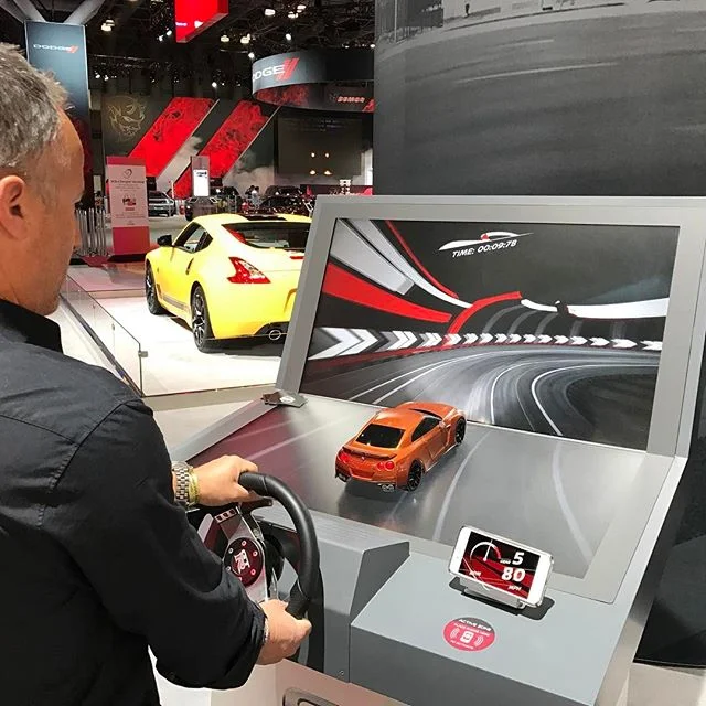 So smart! Integrating an app download to play a racing game at the New York International Auto Show. Who can turn that down? Not @arihorowitz #nyinternationalautoshow #nyias @nyautoshow