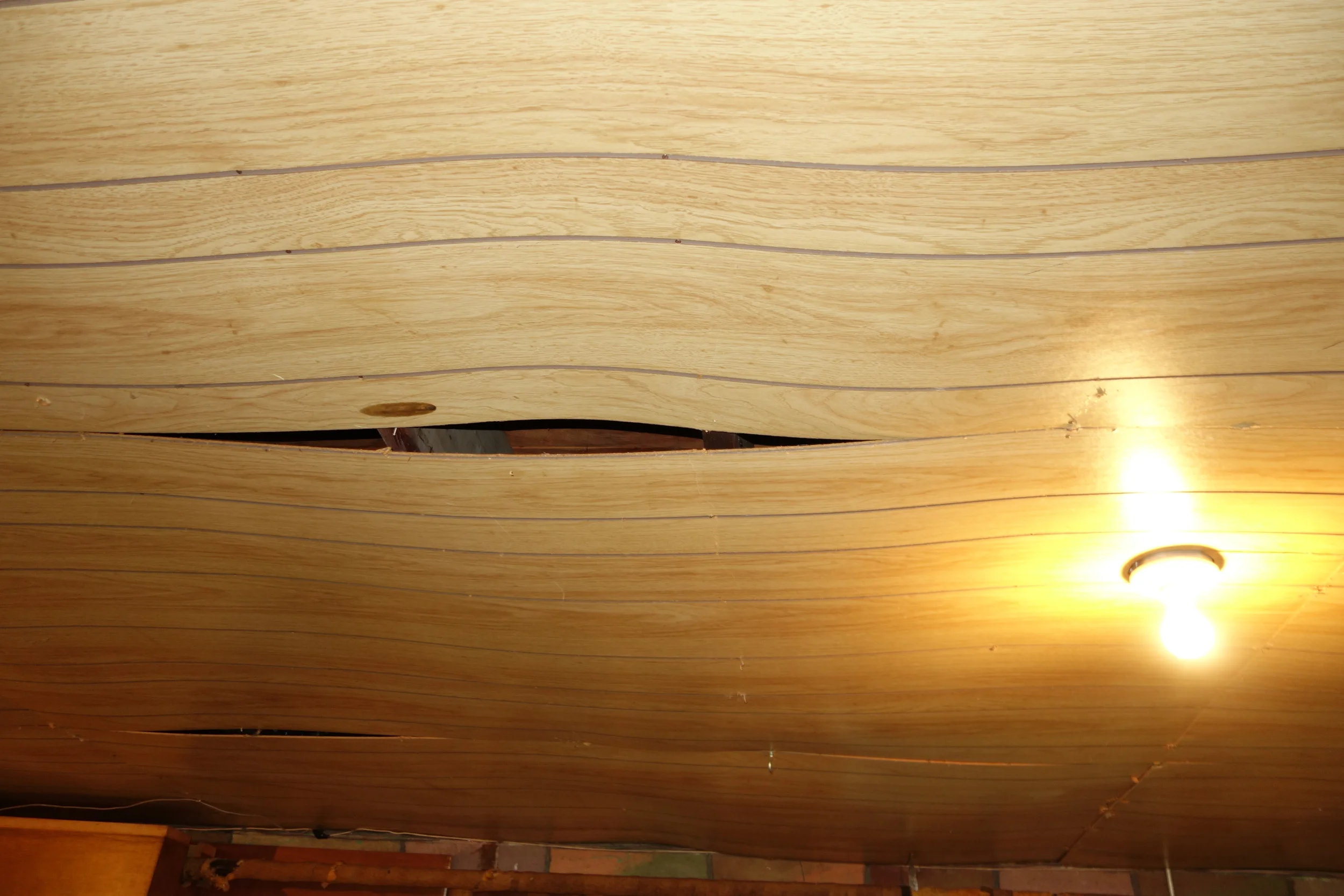 basement shop ceiling that's warped and will come down for access