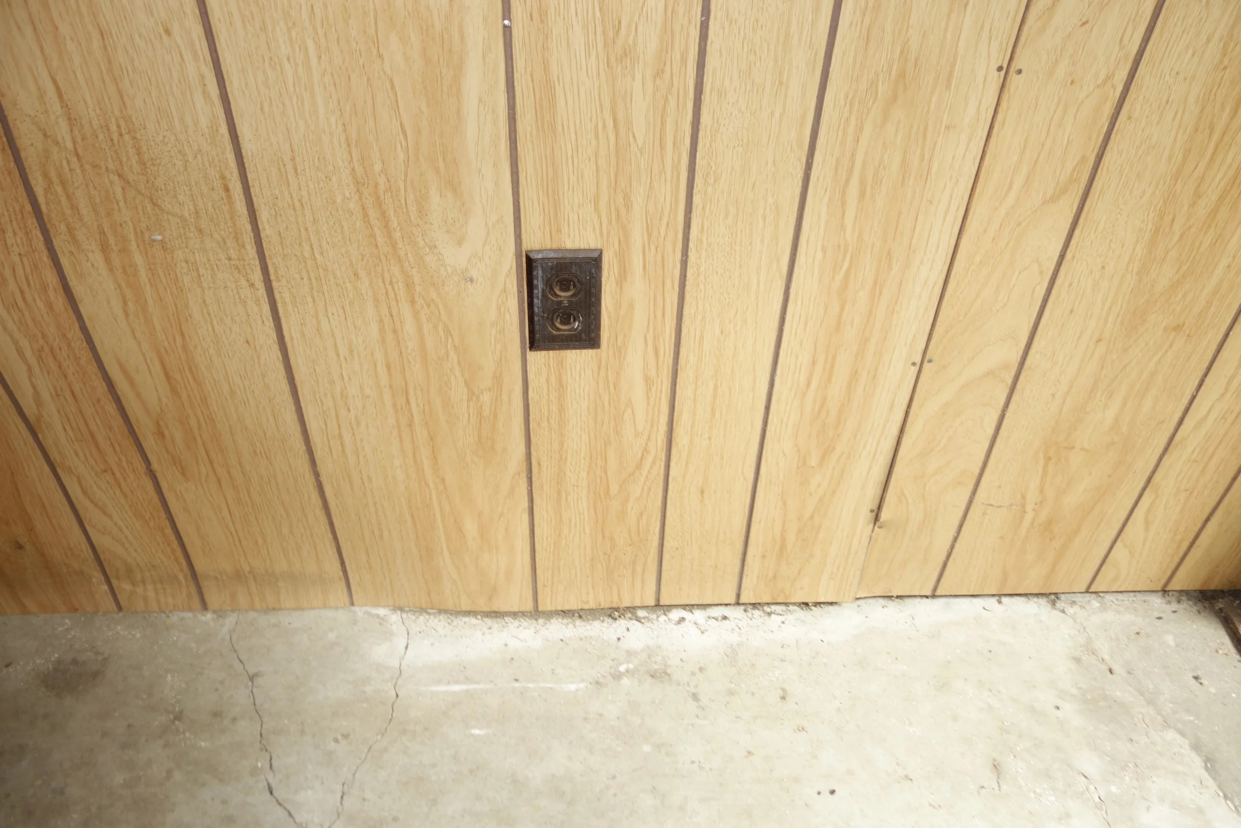 wood paneled wall that he said needed to be replaced