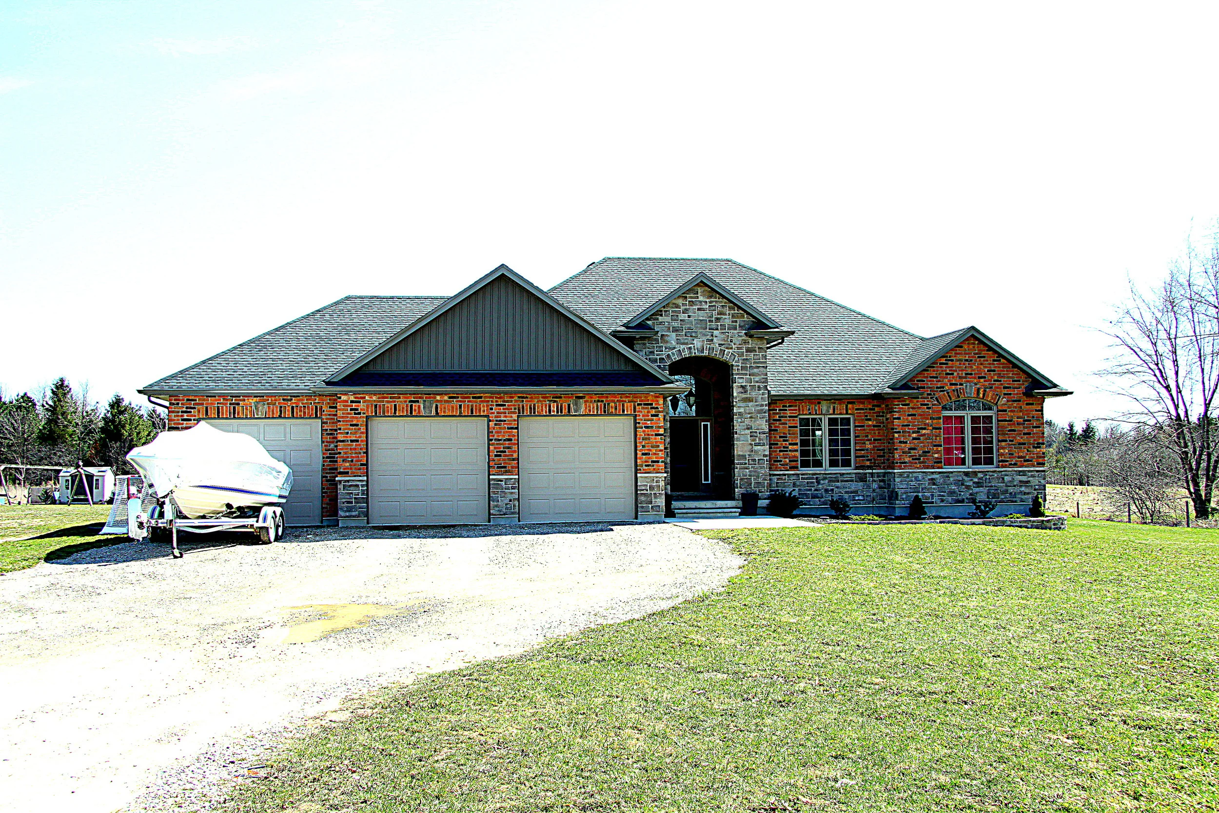 New Home Ranch style brick and stone exterior 3 car garage