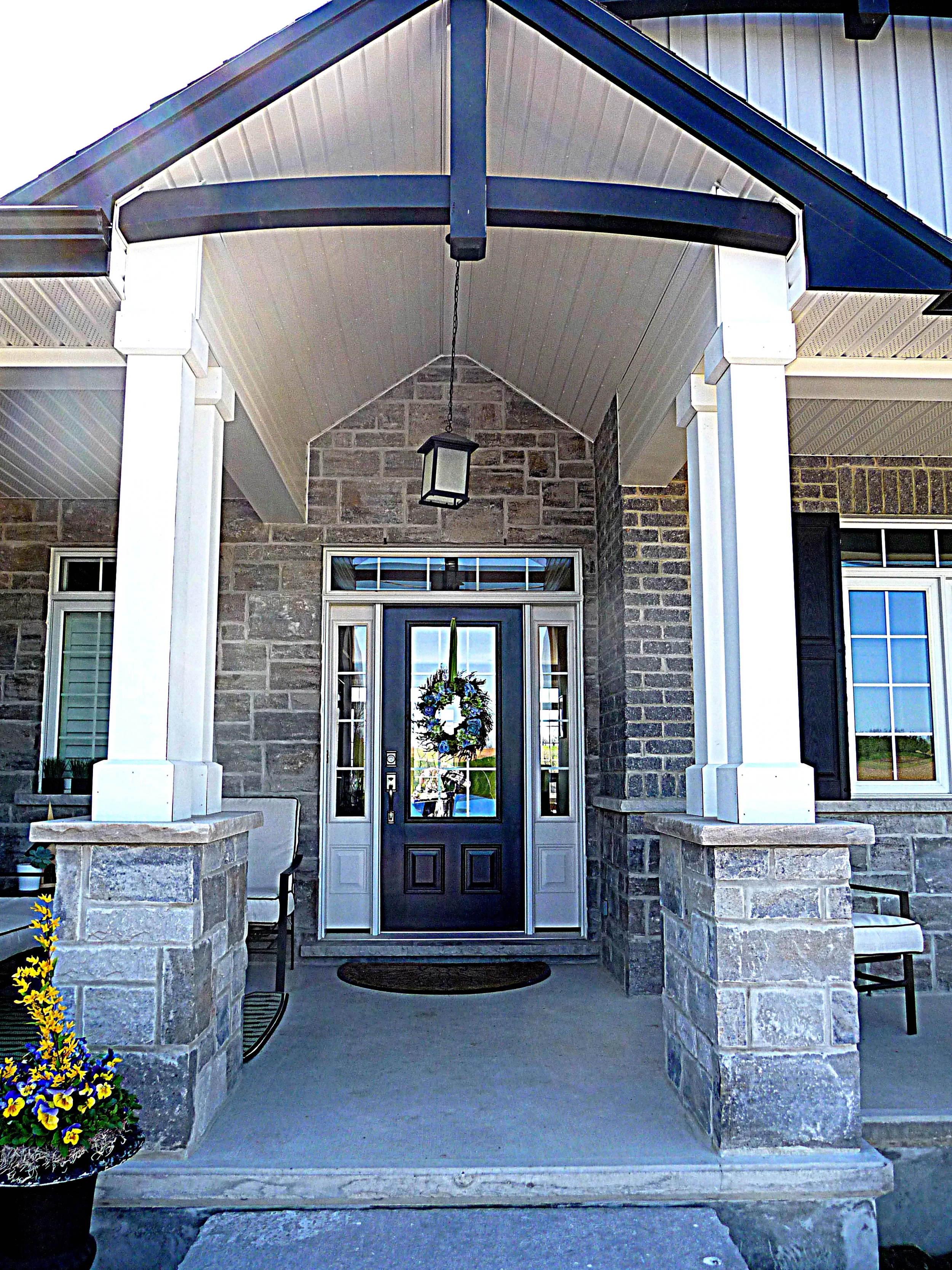 Exterior front entry Stone Columns with brick walls new home