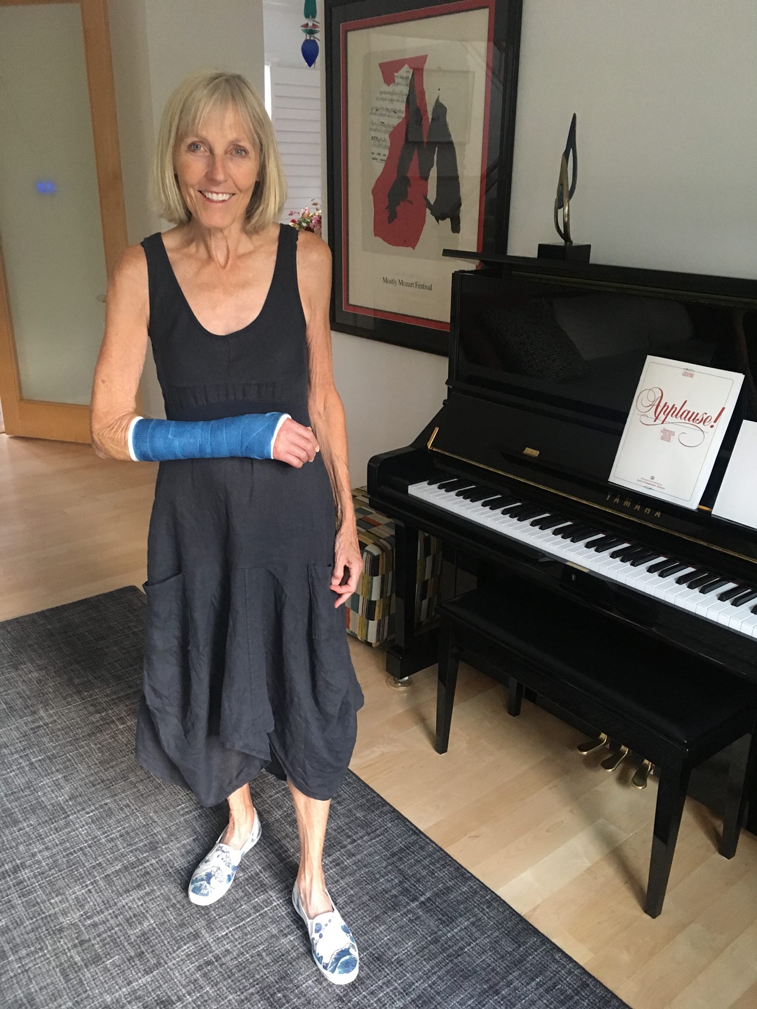 Pat with arm in new blue cast and wearing shoes that Alex created about 10 years ago.