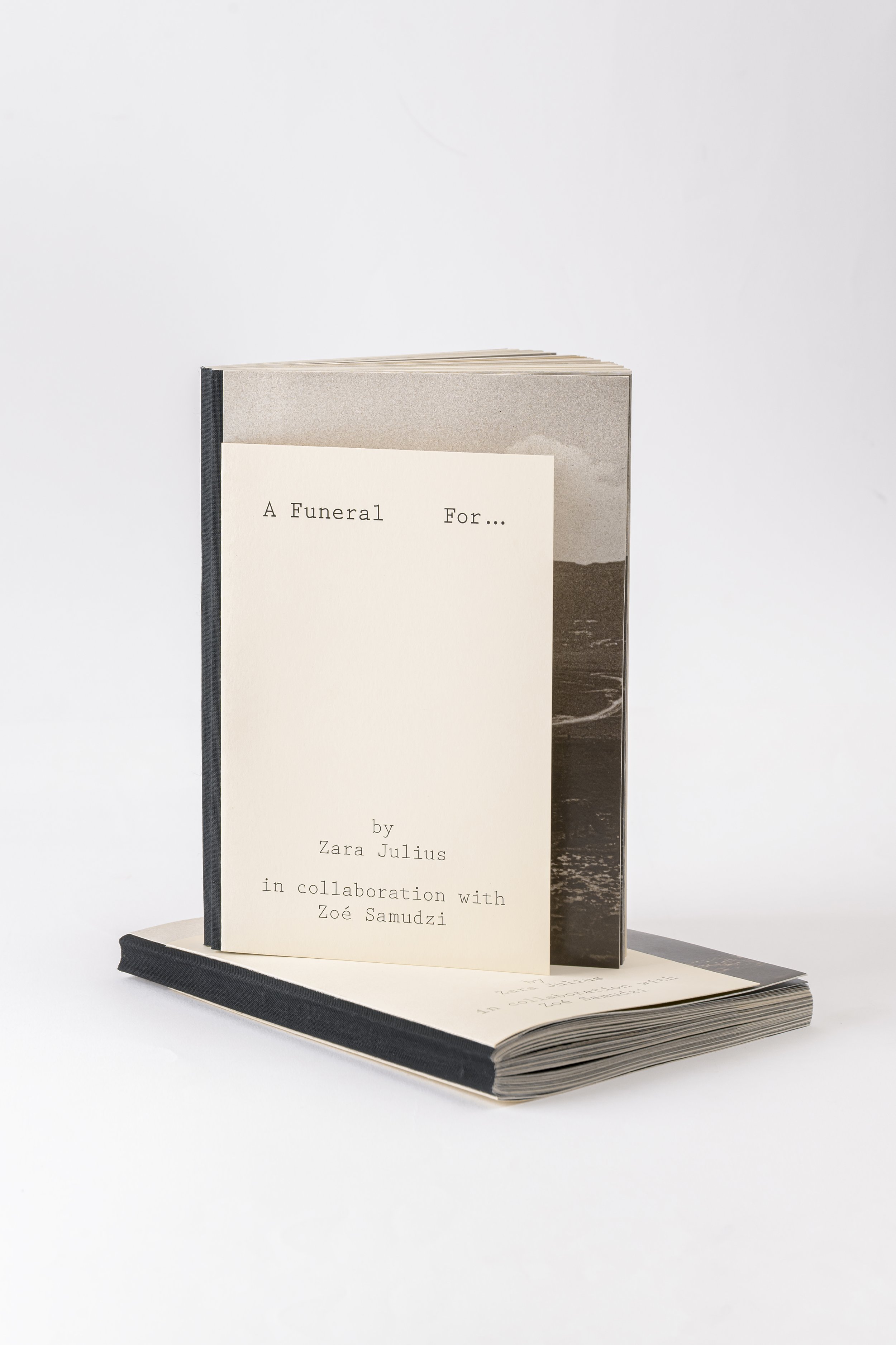 A book titled 'A Funeral For...' by Zara Julius in collaboration with Zoé Samudzi, standing upright and partially open on a white background.