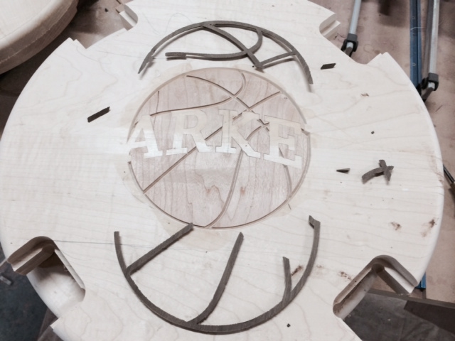 The walnut is then cut and carefully glued in place.