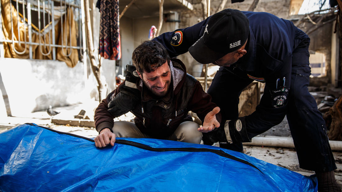 A man grieves for his loved ones, who were found dead in the rubble of a destroyed home