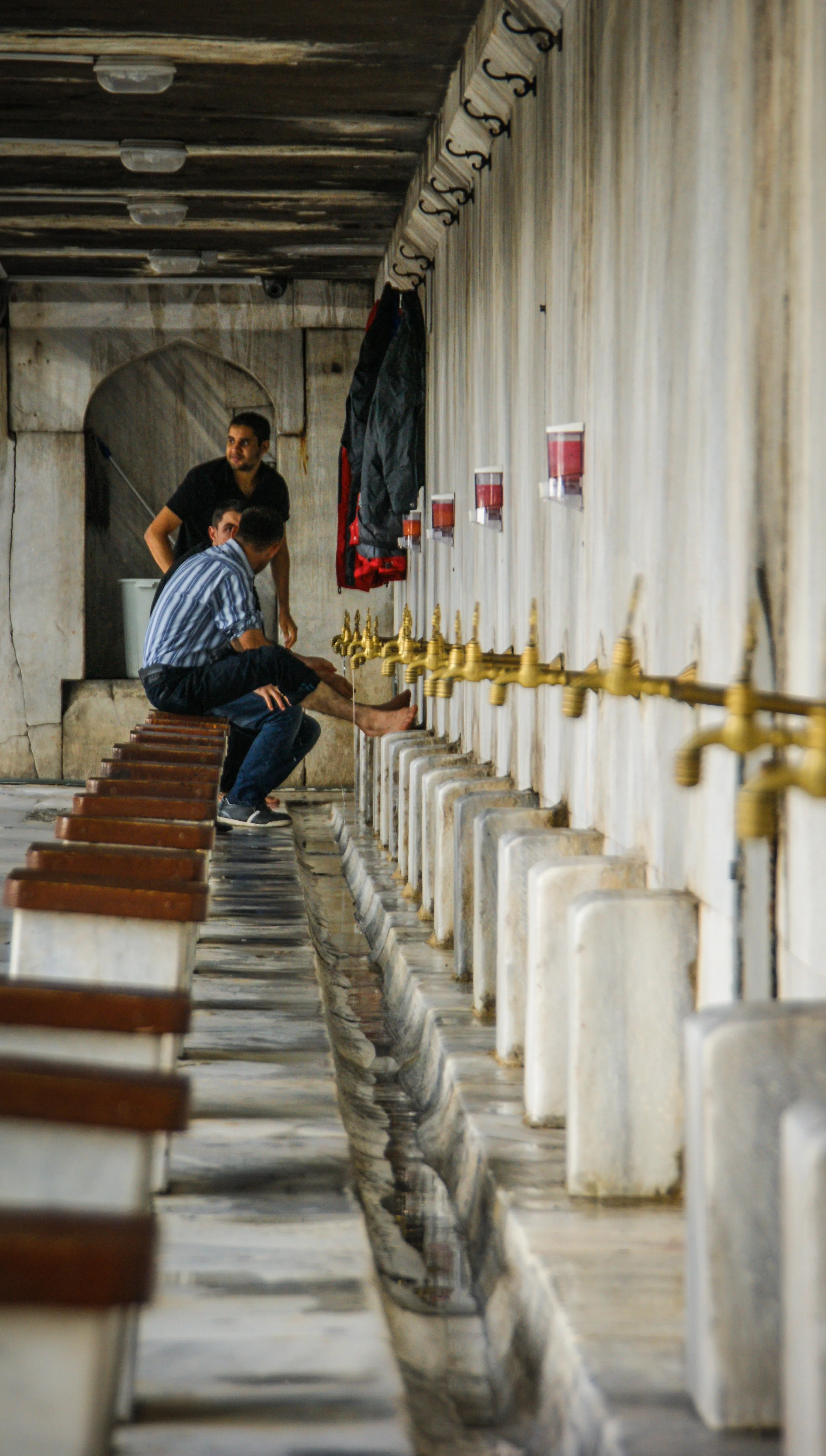   Routines   Men performing Wudu, the Islamic procedure of washing parts of the body before formal prayers,&nbsp;outside the Blue Mosque.  Istanbul, Turkey. 