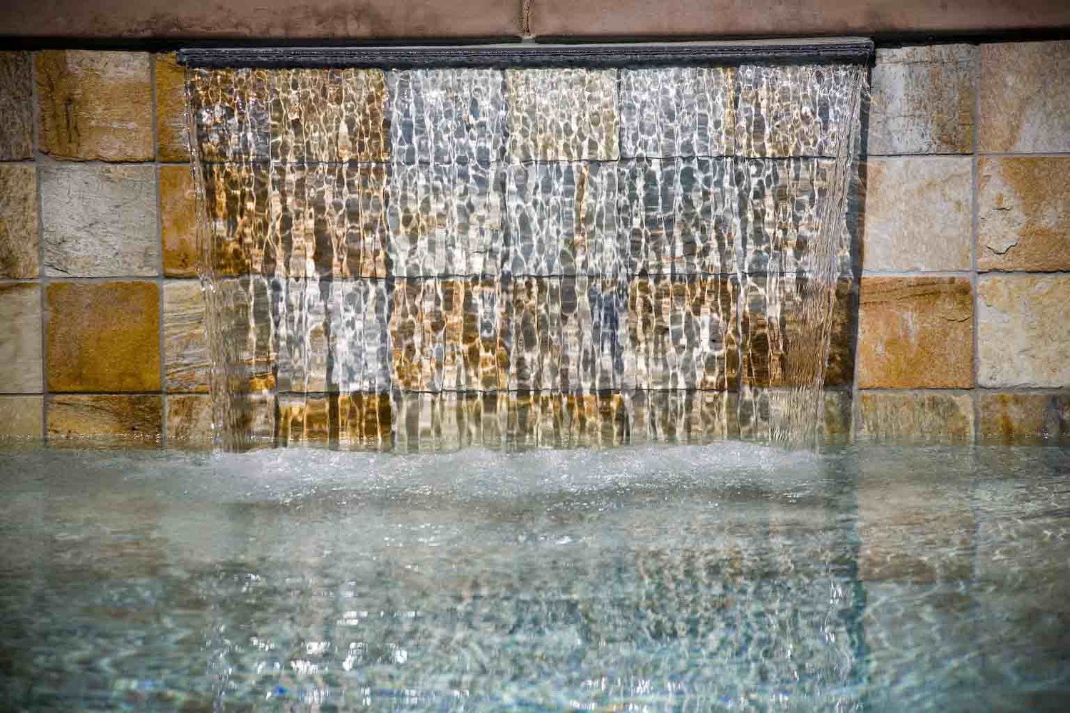 Sheer Descent Waterfalls - Built on a raised wall. It provides a continous sheet of water. 