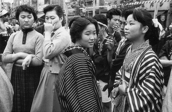 Takeyoshi Tanuma. Modern dress versus traditional dress at the Sanja Matsuri Festival. Asakusa, Tokyo, 1955.