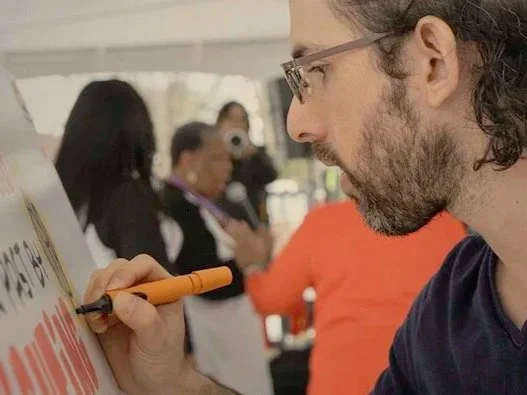 Alejo drawing a graphic recording for Foot Soldiers Park in Selma Alabama