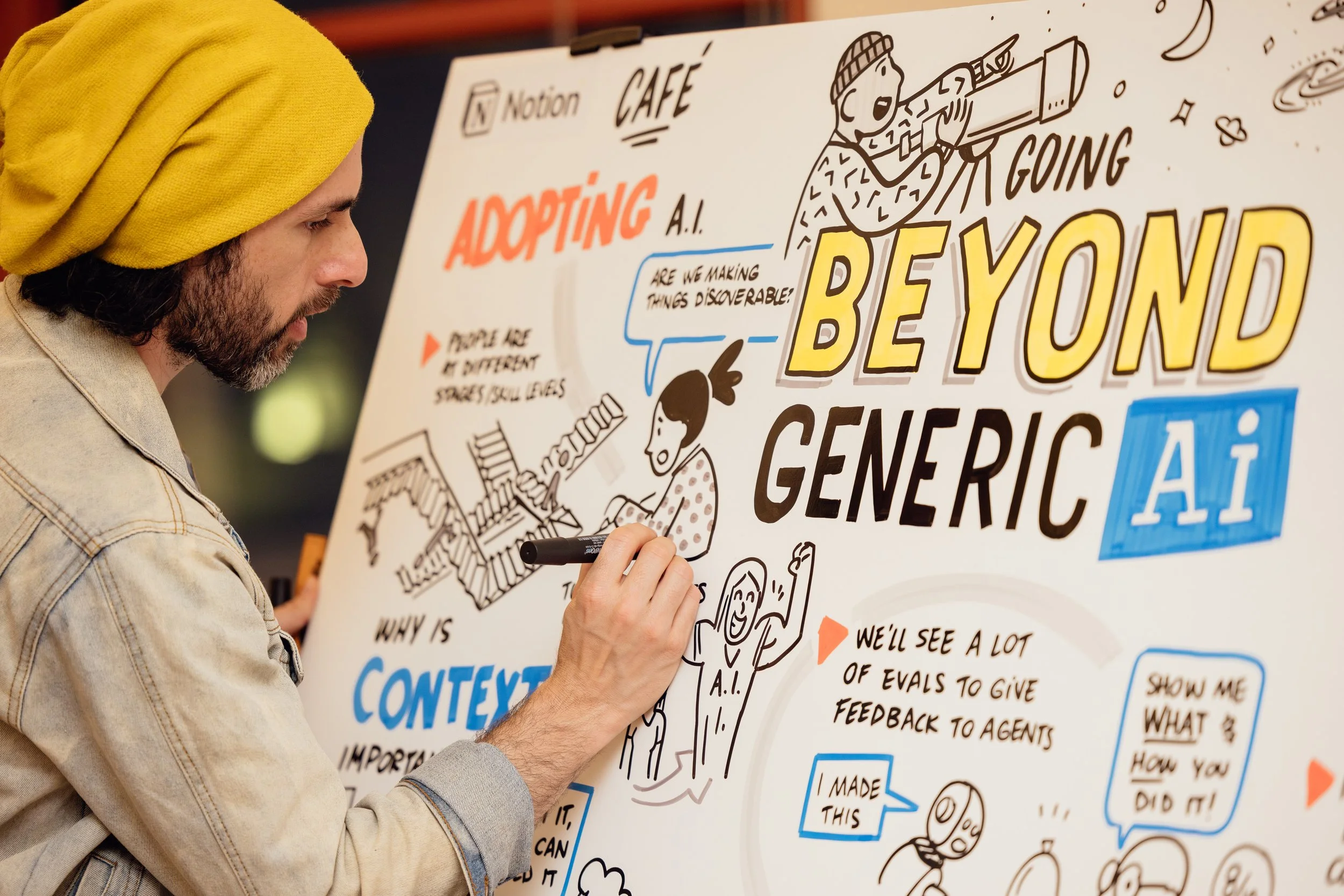 Alejo Porras draws a graphic recording with markers at a Notion event about AI