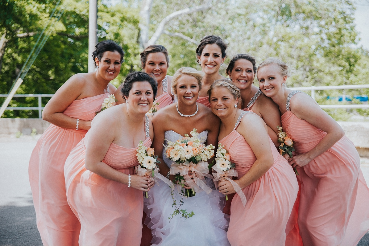 Allie made a gorgeous bride and her bridesmaids looked stunning in their peach gowns! Photo by Shelby Chari Photography .