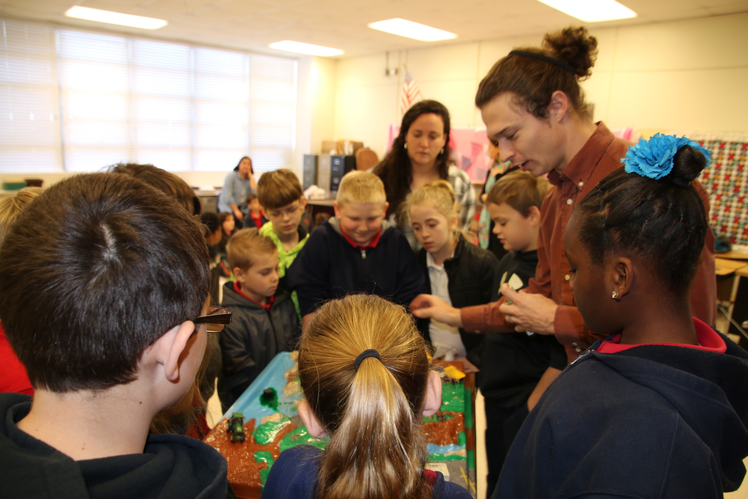 Program Coordinator Cade Kistler uses a hands on activity to educate students on sources of water pollution.