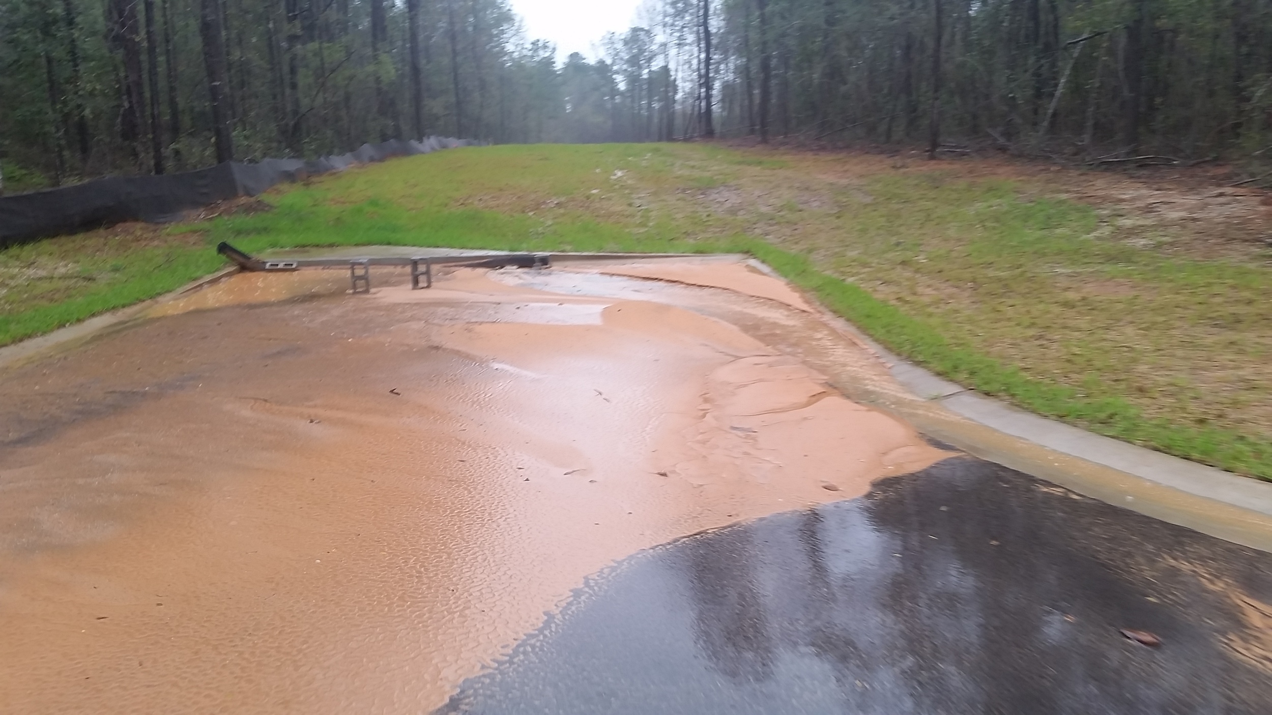 Sediment from a construction site in Baldwin County is washed into a storm drain.