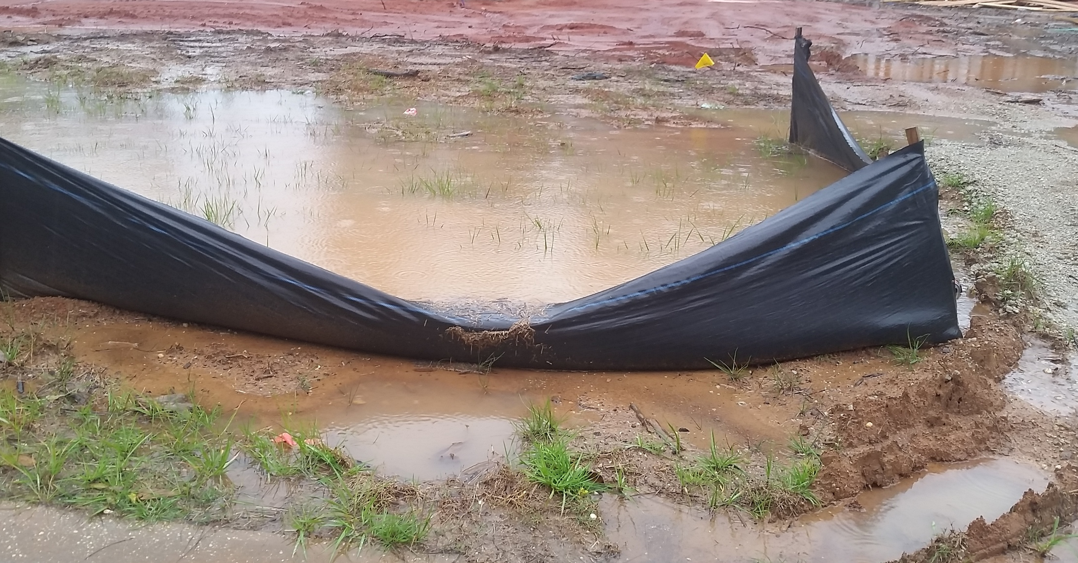 Sediment overflows a poorly maintained silt fence at a construction site in Baldwin County.