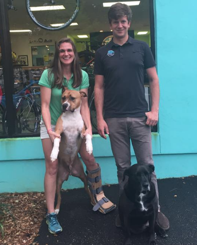 It's a family affair at Pro Cycle & Tri. Katie and Joseph pose with their loyal companions Frank and Chip in front of the shop after our interview. 