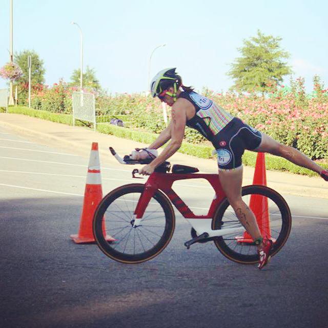 Katie mounts her bike in transition. 