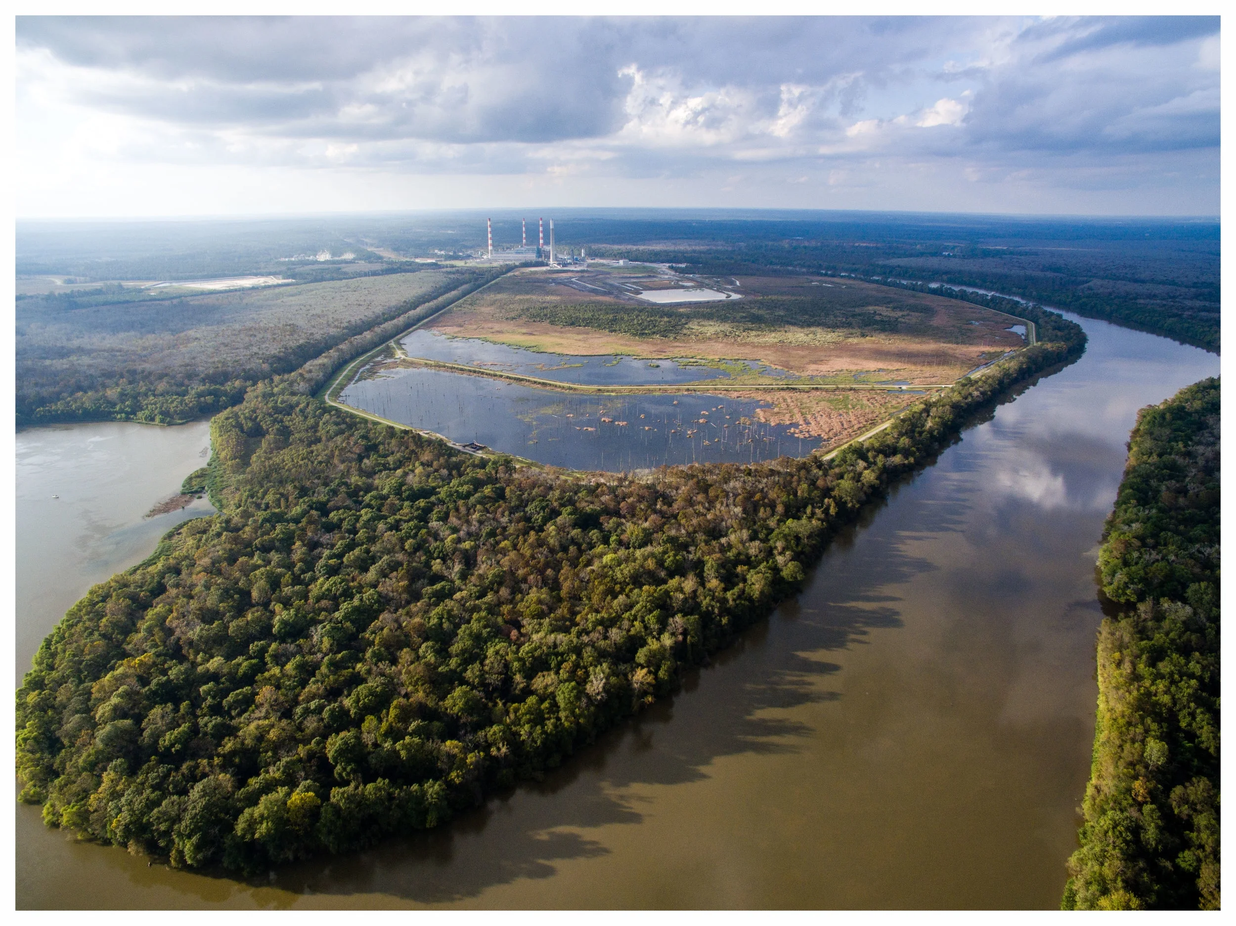 The James M. Barry Electric Generating Plant , is located in Bucks, AL in North Mobile County. Coal ash from the facility is mixed with water and piped into a coal ash pond (pictured above). This pond is located immediately adjacent to the Mobile River and Mobile-Tensaw Delta and contains more than 21 million tons of coal ash.