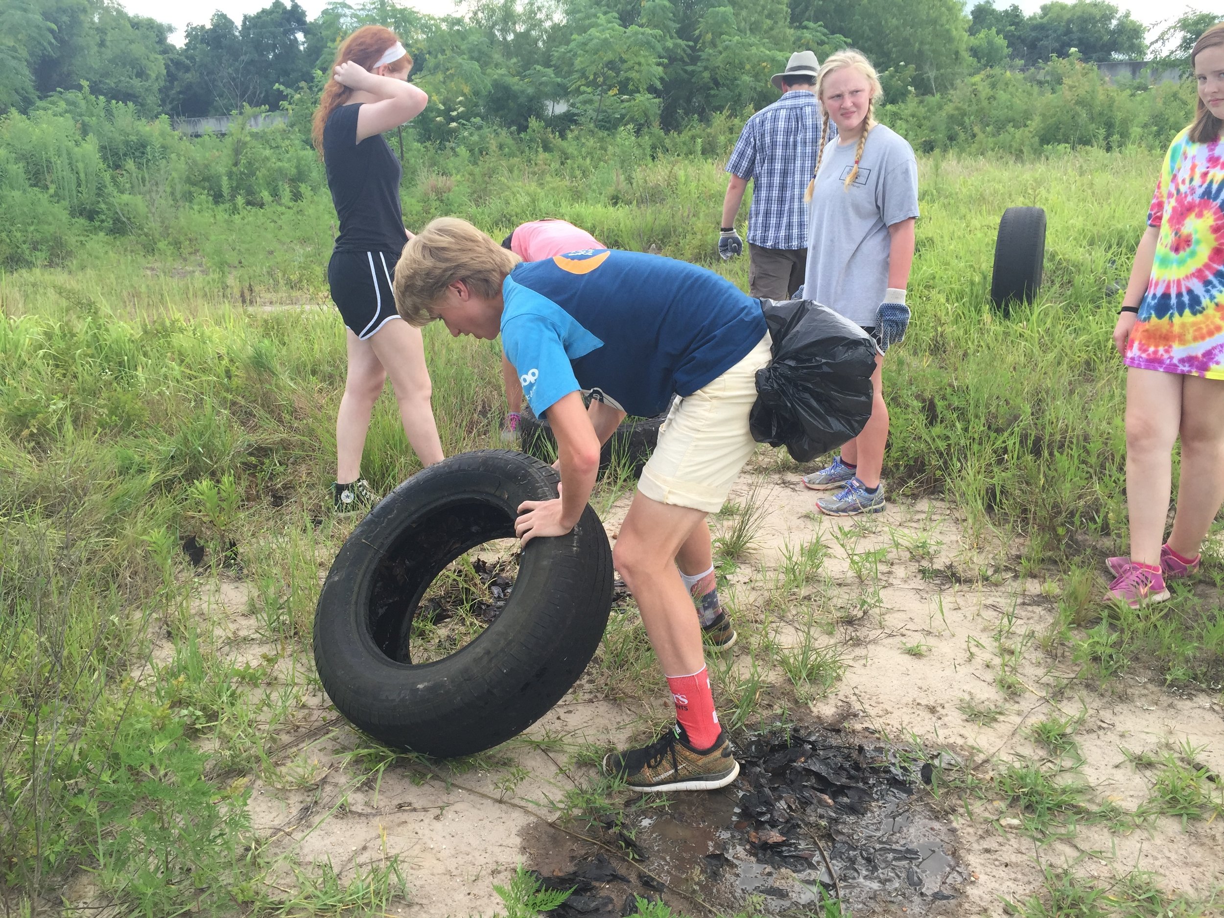 Visiting students with the Urban Mission Camp find numerous tires and other debris each summer near One Mile Creek during litter cleanups with Mobile Baykeeper.
