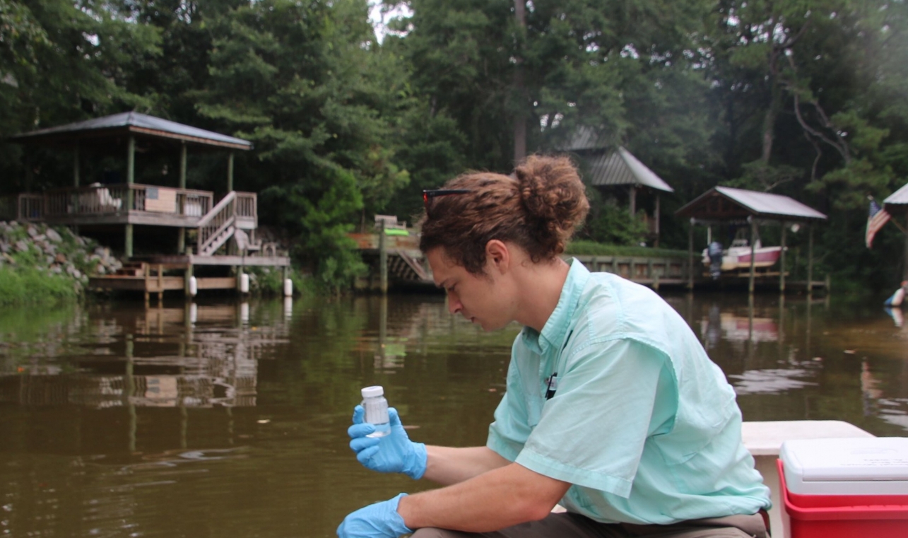 Program Director, Cade Kistler, tests for bacteria in Fly Creek.