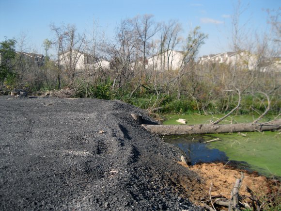 Asphalt parking lot illegally constructed in wetland. (Photo Credit: U.S. Army )