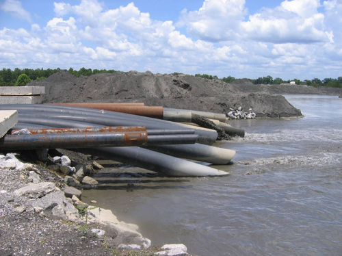 Coal Ash pours out of pipes into the more than 600 acre pond at Plant Barry in Bucks, Al. (Picture - U.S. EPA)